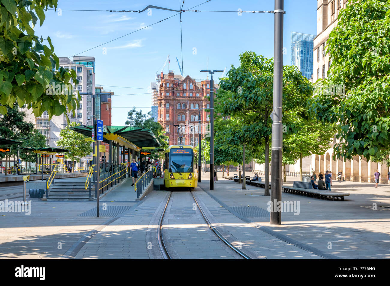 Modern Metrolink tram picking up passengers at St Peters Square in the centre of Manchester, UK Stock Photo