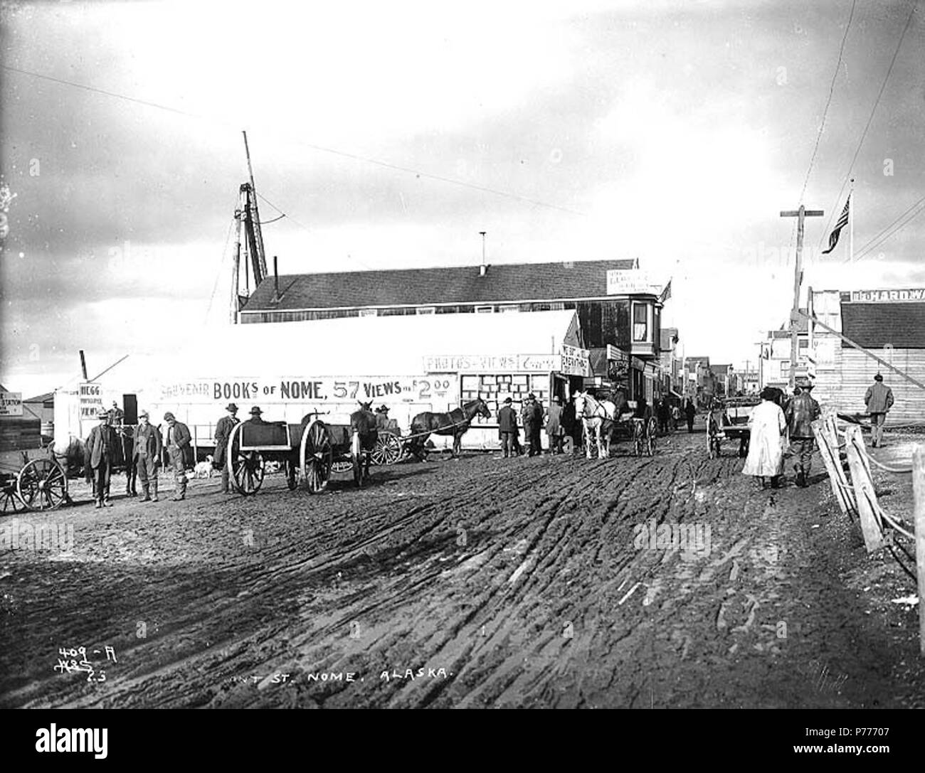 . English: Front St. showing Hegg's photography studio, Nome, Alaska, ca. 1900. English: Sign on studio reads: 'Souvenir books of Nome. 57 views for $2.00. Photos and views. E.A. Hegg' Caption on image: 'Front St. Nome, Alaska' Original image in Hegg Album 5, page 22 . Original photograph by Eric A. Hegg 1623; copied by Webster and Stevens 409.A Subjects (LCTGM): Streets--Alaska--Nome; Advertising--Alaska--Nome; Carts & wagons--Alaska--Nome; Photographic studios--Alaska--Nome; Tents--Alaska--Nome Subjects (LCSH): Front Street (Nome, Alaska)  . circa 1900 5 Front St showing Hegg's photography s Stock Photo