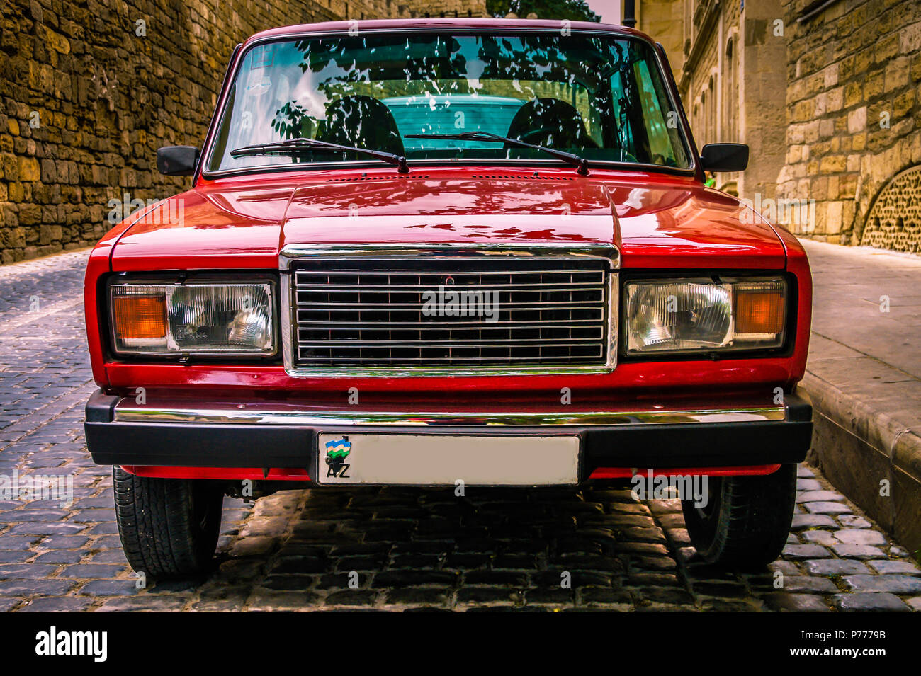 View from front at russian classic car Lada Auto. Red soviet motor auto in the city street. Car front view from side. Car front exterior. Car front Stock Photo