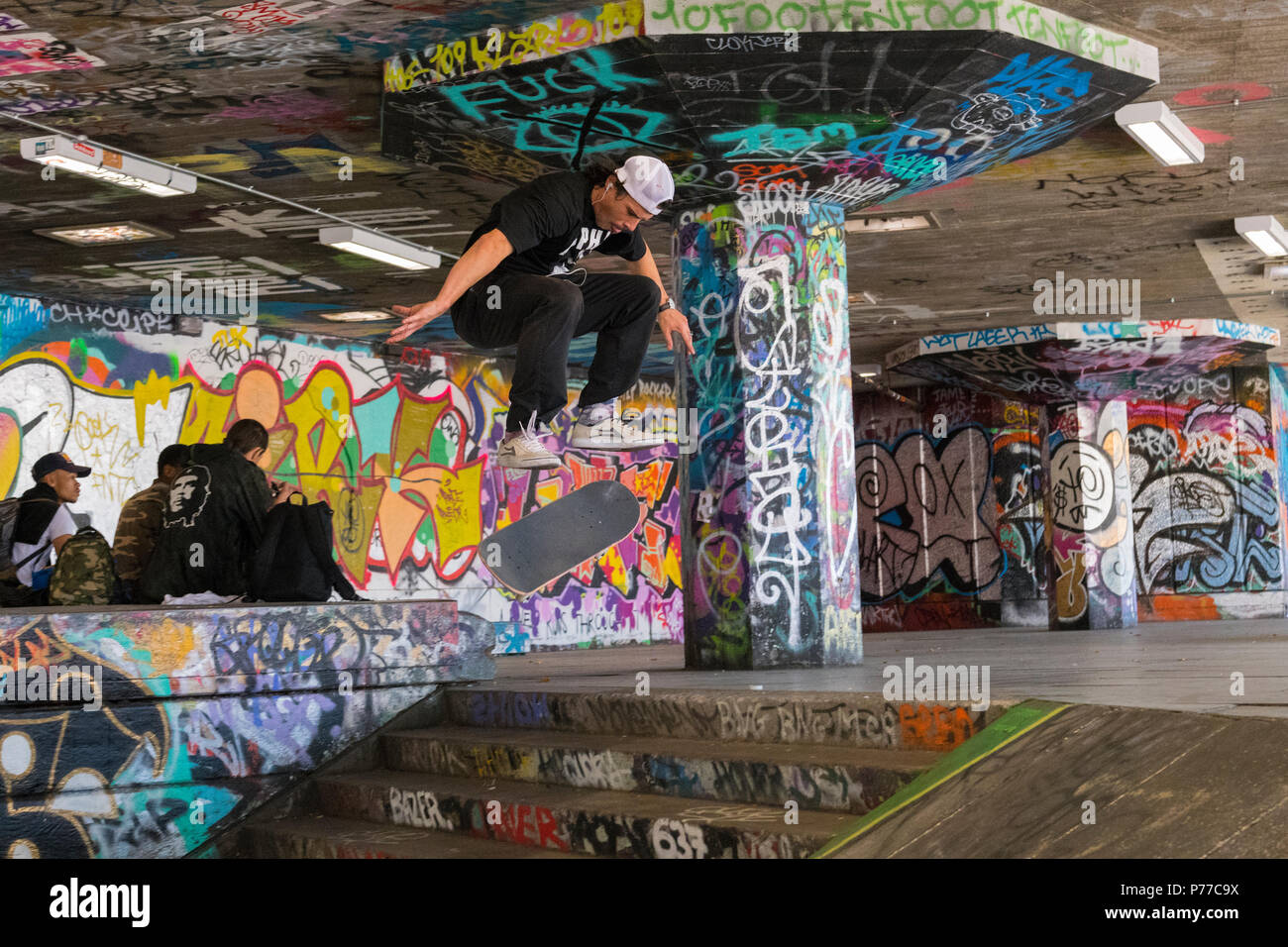 London Southbank Centre Skatepark graffiti skateboarder in air flight down  stairs steps skateboarding jump trick action skill acrobatic Stock Photo -  Alamy