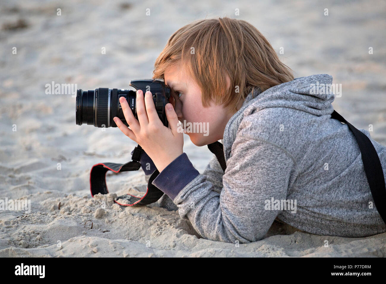 young boy taking photos at a beach Stock Photo