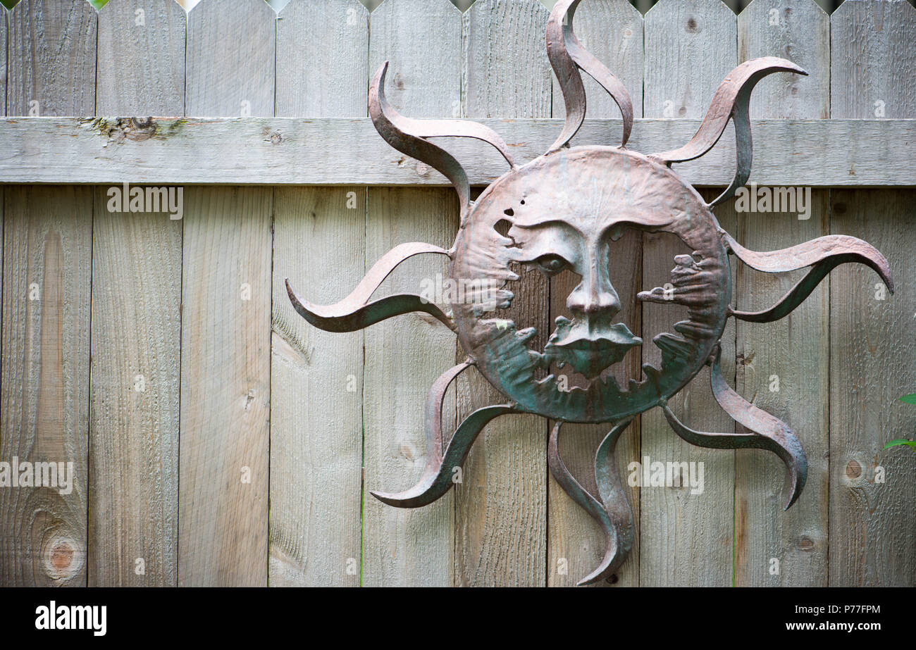 Wooden fence with abstract sun made from tin Stock Photo - Alamy