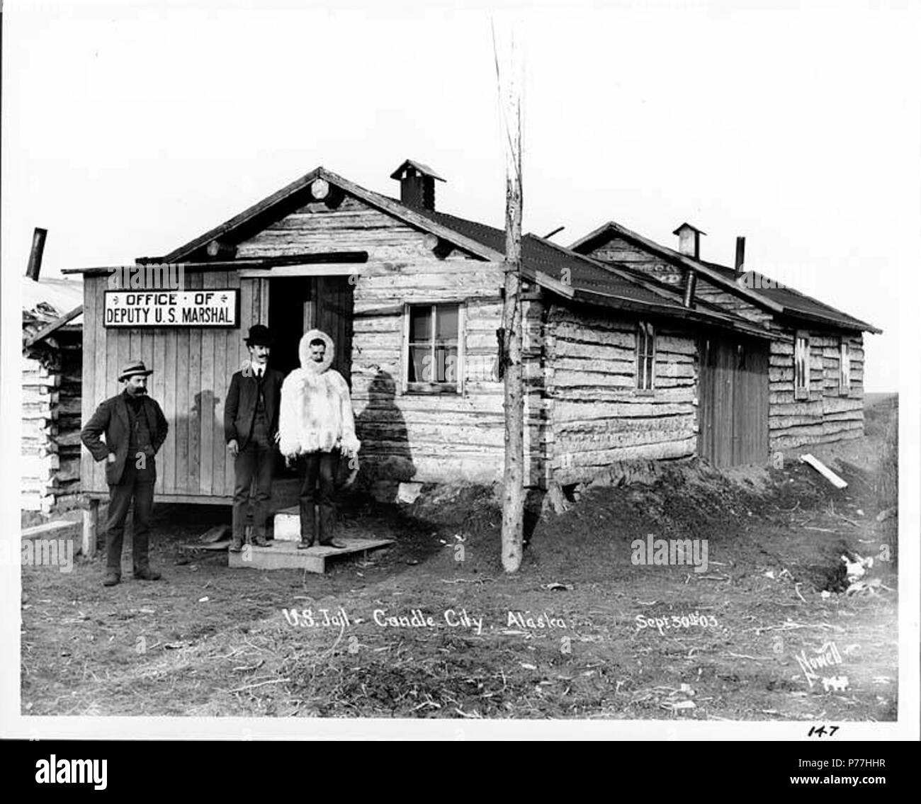. English: Jail and office of the U.S. Deputy Marshall, Candle City, September 30, 1903 . English: Caption on image: U.S. Jail, Candle City, Alaska. Sept. 30th 03. Nowell 147. Subjects (LCTGM): Jails--Alaska--Candle; Law enforcement officers--Alaska--Candle; Log buildings--Alaska--Candle; Fur garments Subjects (LCSH): Marshalls--Alaska--Candle; Parkas--Alaska--Candle  . September 1903 6 Jail and office of the US Deputy Marshall, Candle City, September 30, 1903 (NOWELL 41) Stock Photo
