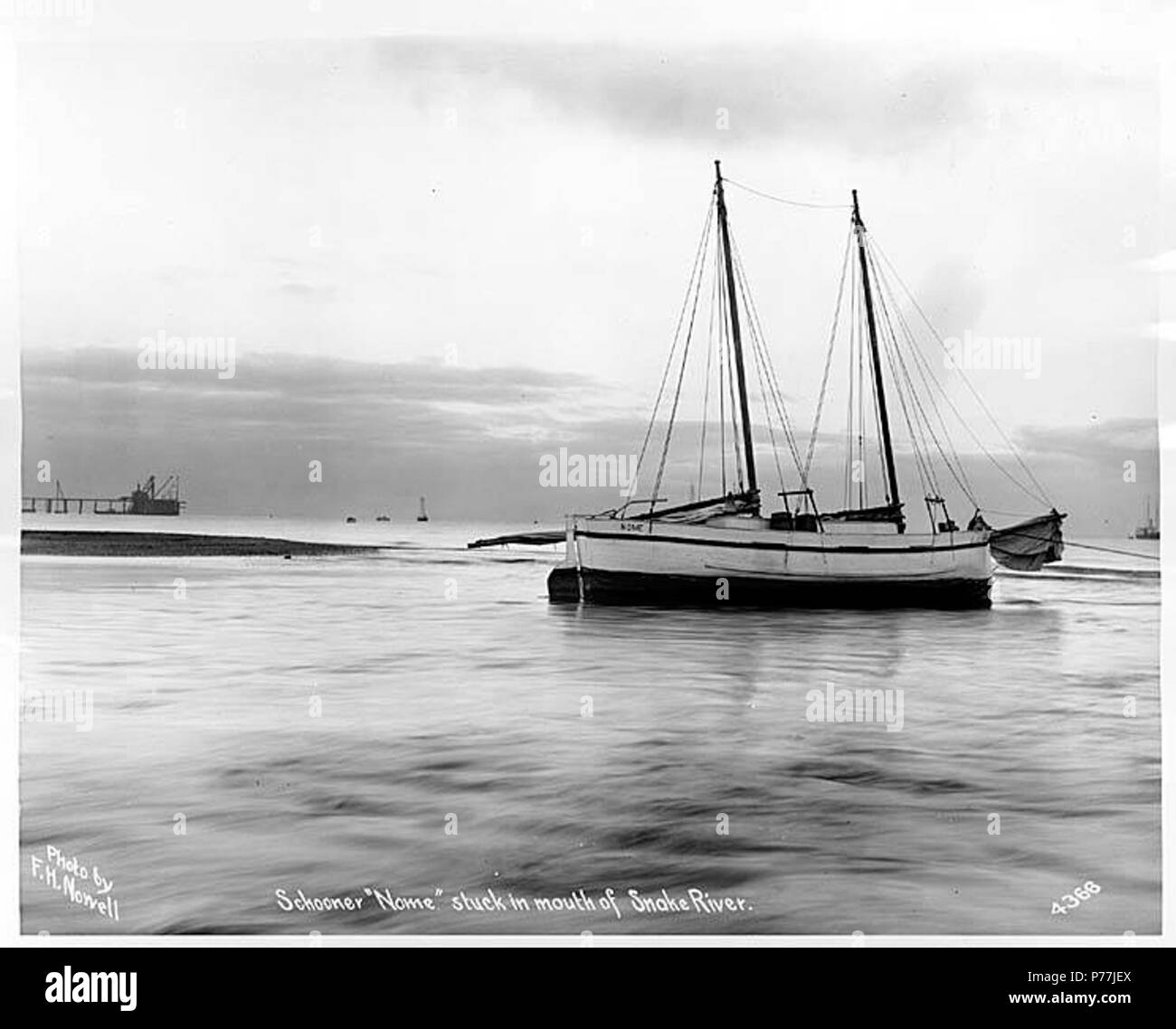 . English: Schooner NOME aground at the mouth of Snake River, Alaska, ca. 1904 . English: Caption on image: Schooner Nome stuck in mouth of Snake River. Photo by F.H. Nowell, 4366 Subjects (LCTGM): Ship accidents--Alaska--Snake River; Rivers--Alaska Subjects (LCSH): Nome (Schooner); Snake River (Alaska)  . circa 1904 11 Schooner NOME aground at the mouth of Snake River, Alaska, ca 1904 (NOWELL 143) Stock Photo