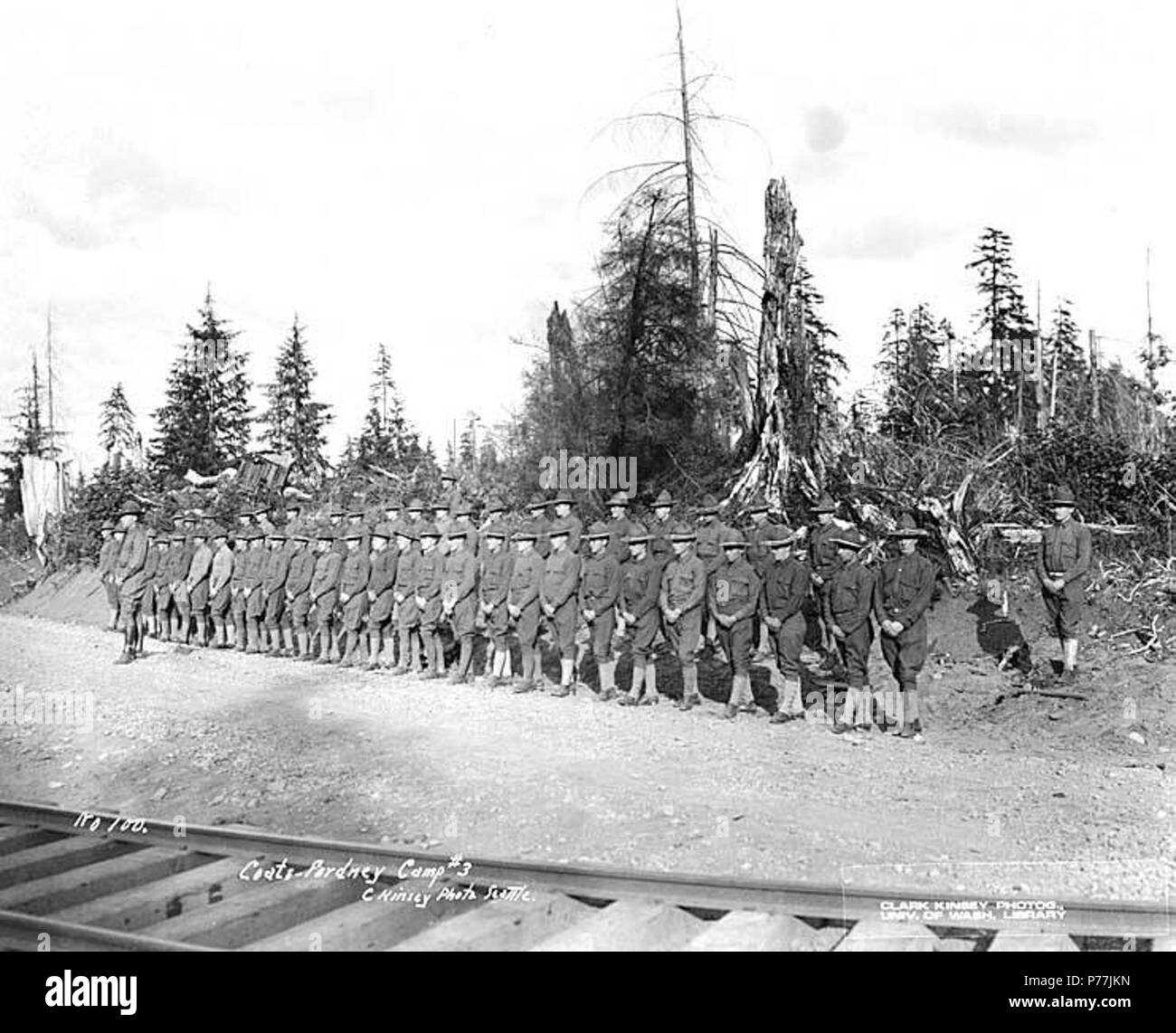 . English: Spruce Division soldiers at Coats-Fordney Lumber company camp no. 3, ca. 1918 . English: Caption on image: Coats-Fordney Camp No. 3. C. Kinsey Photo, Seattle. No. 100 PH Coll 516.4599 The Coats-Fordney Lumber Company started out as the A.F. Coats Lumber Company in 1905, headquartered in Aberdeen. It became the Coats-Fordney Lumber Company in 1910, and by 1924, it was called the Donovan-Corkery Lumber Company. Subjects (LCTGM): Soldiers--Washington (State); Railroad tracks--Washington (State); Lumber camps--Washington (State); United States. Army. Spruce Division--People--Washington  Stock Photo