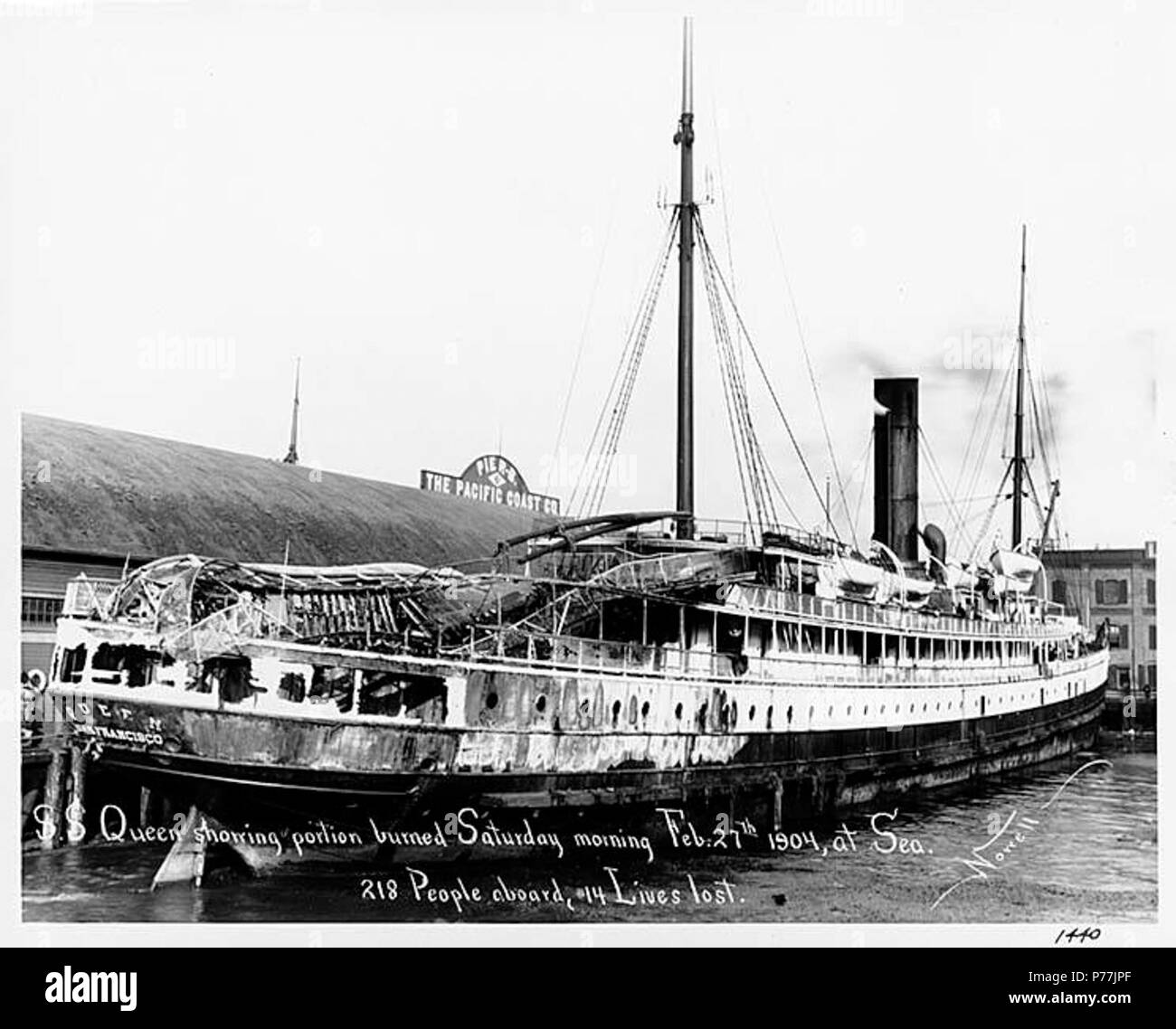 . English: Steamship QUEEN at dock in Port Townsend, Washington, following a fire at sea on February 27, 1904 . English: Caption on image: S.S. Queen showing portion burned Saturday morning Feb. 27th 1904, at sea. 218 people aboard, 14 lives lost. Nowell, 1440 The steamship QUEEN of the Pacific Coast Steamship Co. was on her scheduled passenger run up the coast from San Francisco to Puget Sound when, off Tillamook Head, Oregon, at four o'clock on the morning of February 27, 1904, fire broke out below decks and quickly enveloped the ship's stern. The captain and crew battled the blaze with utmo Stock Photo