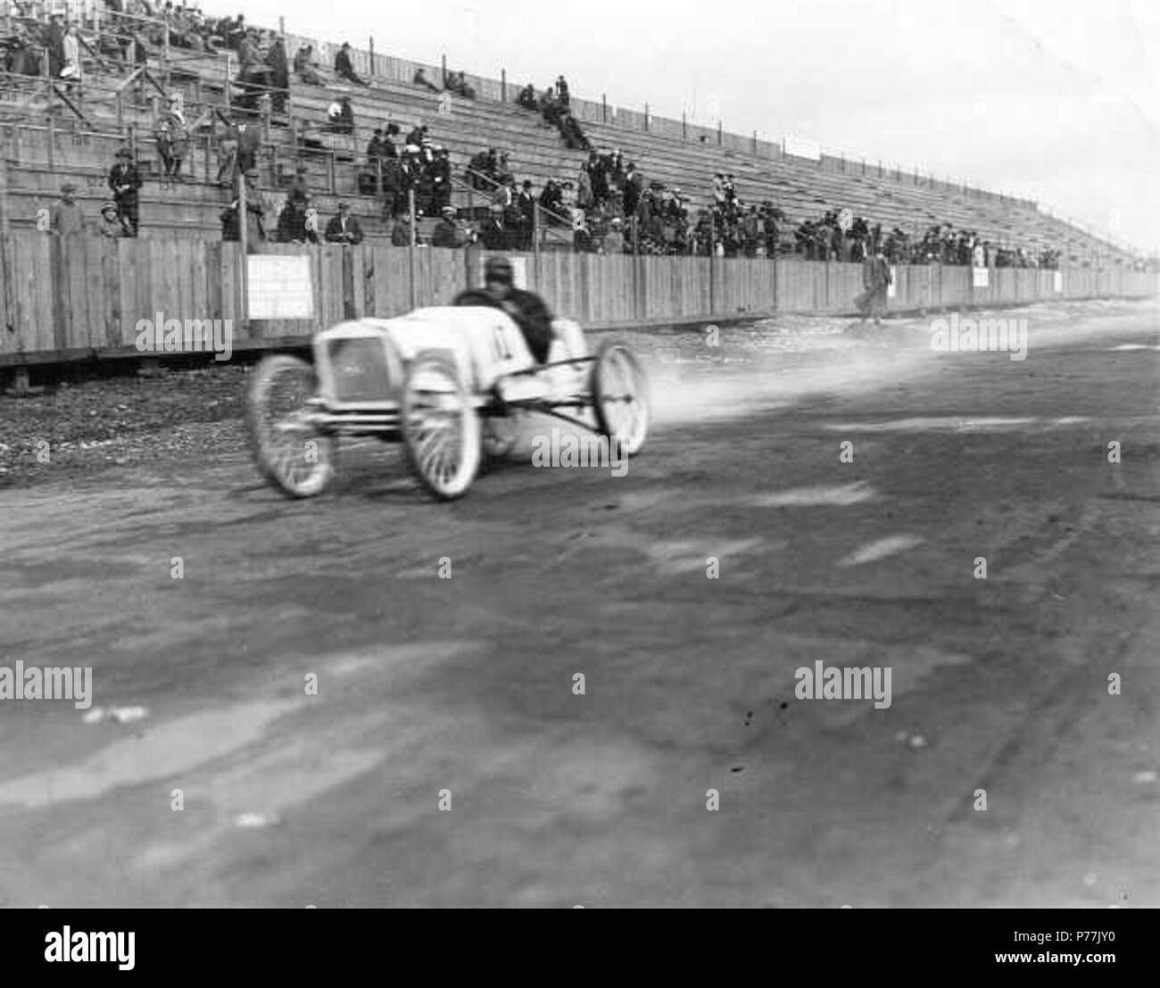 English: This unidentified driver is believed to be piloting a 'cycle carriage' or car during speed trials at the Tacoma Speedway in September of 1914. There were 14 entries, mostly from Southern California and including future star Harry Hartz, for the Labor Day races. Four of the junior drivers were from Tacoma. Vehicles had to reach a speed of 40 mph to qualify. These cars had for the most part motorcycle engines and were smaller than regular race cars. Although days preceding the event were dry, the Labor Day race was cancelled due to rain and a rescheduled race the following week was also Stock Photo