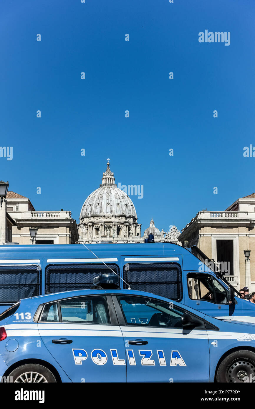 Police cars patrol in Via della Conciliazione by Saint Peter’s Basilica. Vatican City State. Rome, Italy, Europe Copy space, clear blue sky, close up. Stock Photo