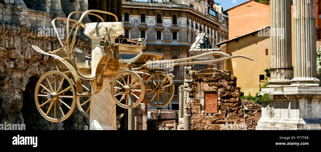 Golden carriage, “The coah” insallation in front of Teatro Marcello and columns from Apollo Sosiano's Temple, Marcellus Theatre Theater. Rome, Italy Stock Photo