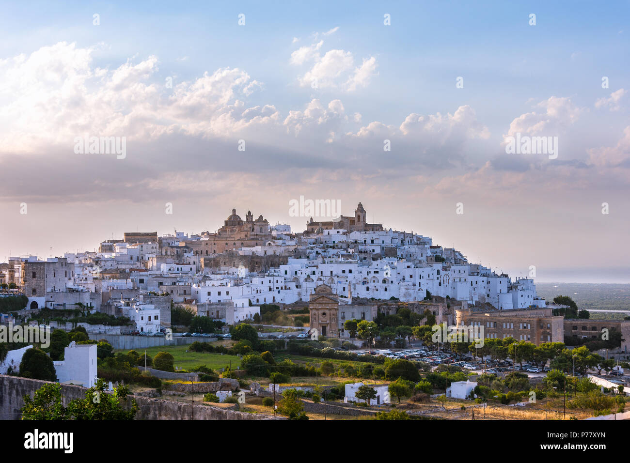 Panoramic view of the white and old city of Ostuni on a hilltop and with the cathedral on top on a sunny afternoon. Puglia, Italy Stock Photo