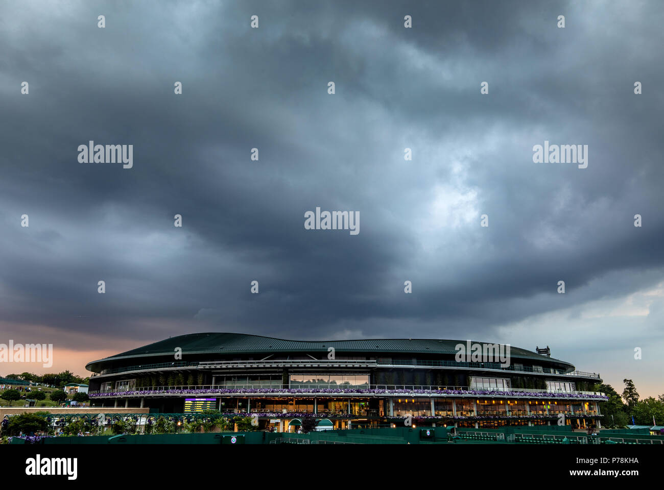 Rain falls on day three of the Wimbledon Championships at the All England Lawn Tennis and Croquet Club, Wimbledon. Stock Photo