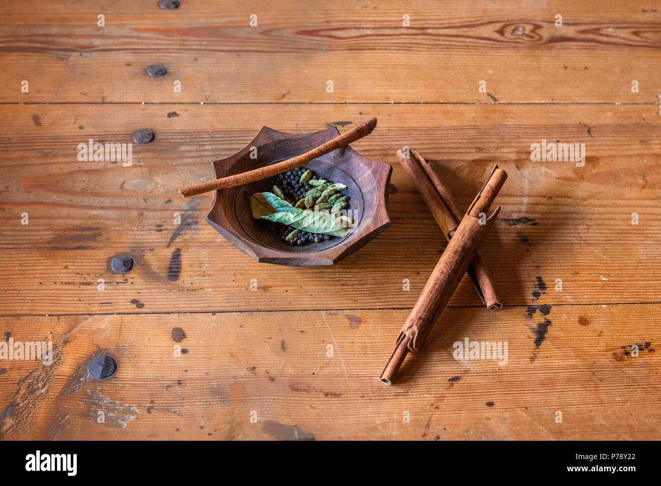 Cinnamon and pepper arranged on a old table Stock Photo