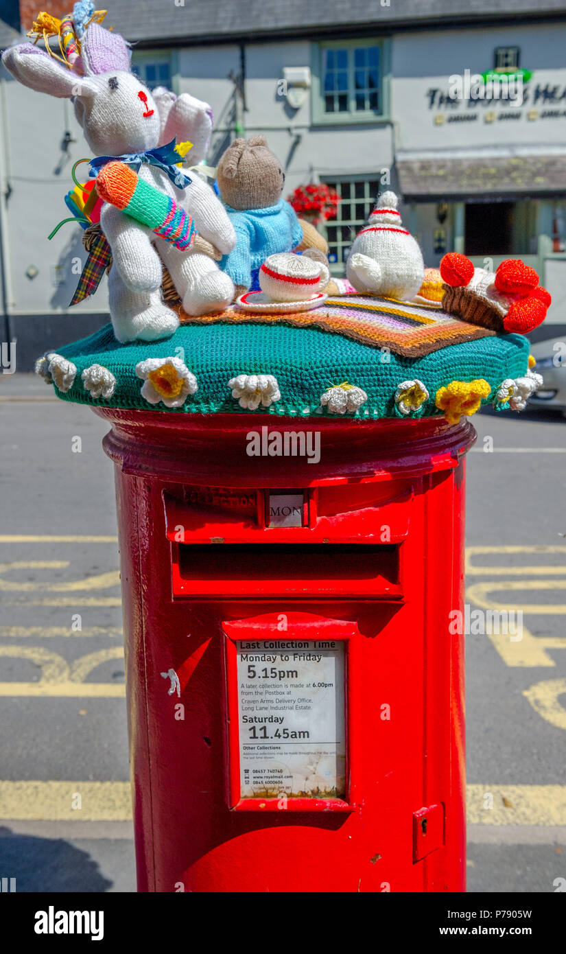 Knitted animals at a tea party on top of a red letter box Stock Photo -  Alamy