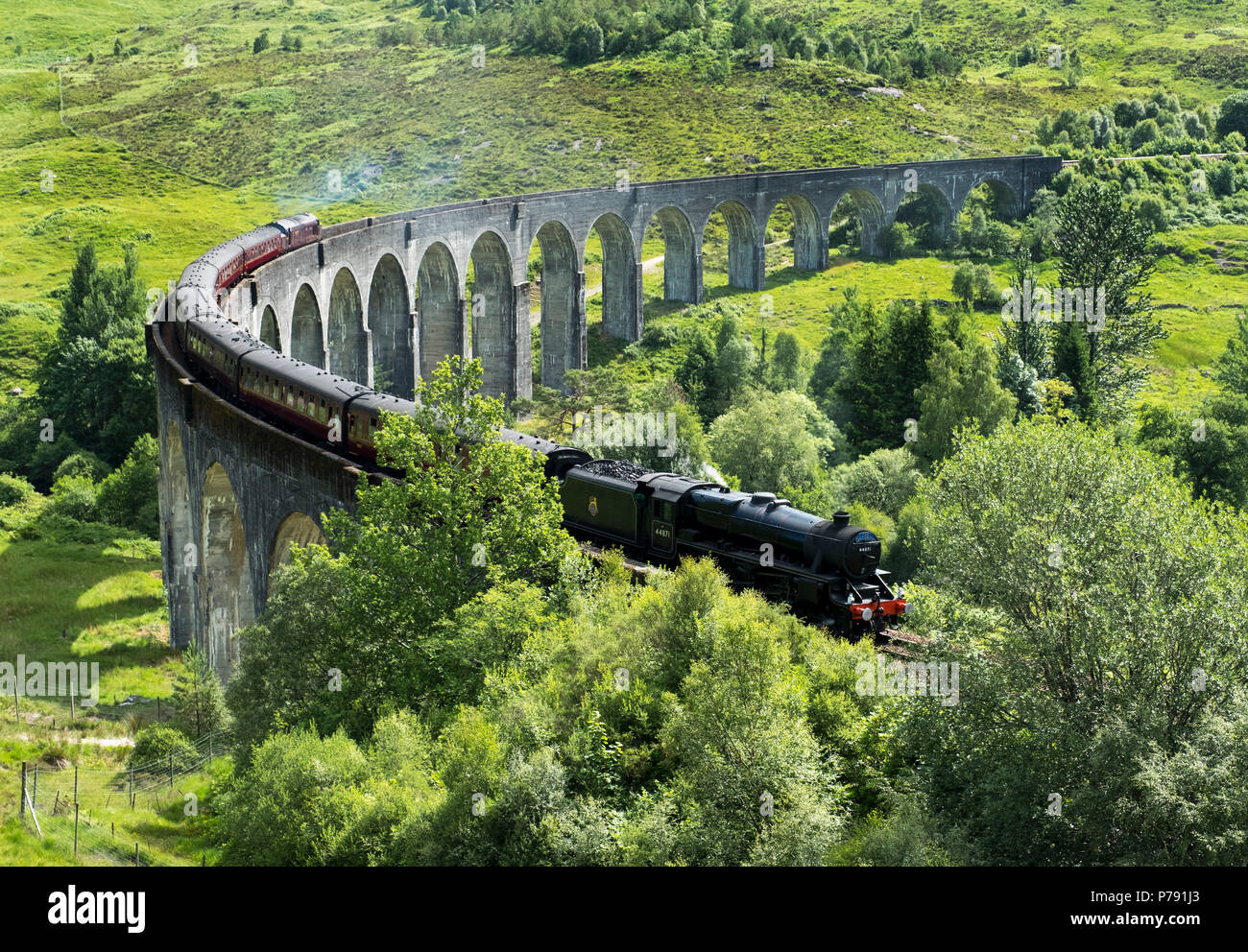 The Jacobite Express also known as the Hogwarts Express crosses the Glenfinnan Viaduct on route between Fort William and Mallaig. Stock Photo