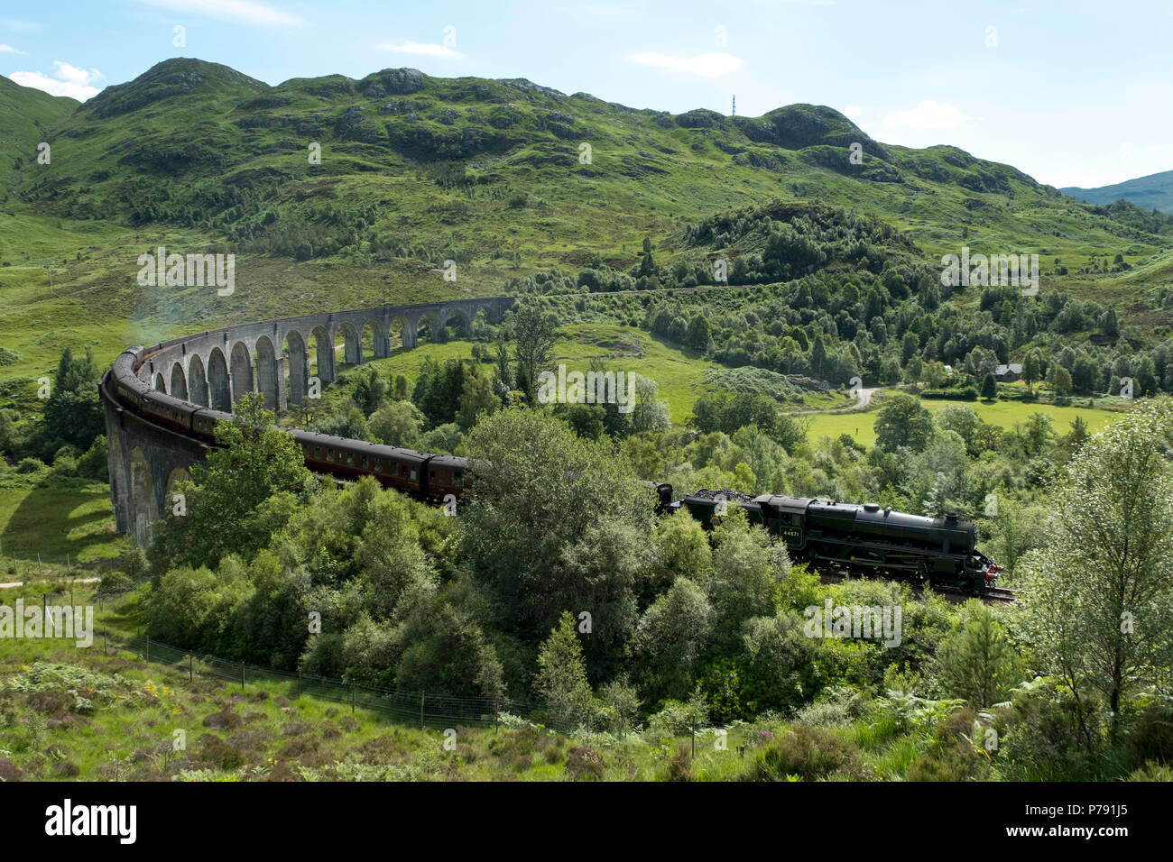 The Jacobite Express also known as the Hogwarts Express crosses the Glenfinnan Viaduct on route between Fort William and Mallaig. Stock Photo
