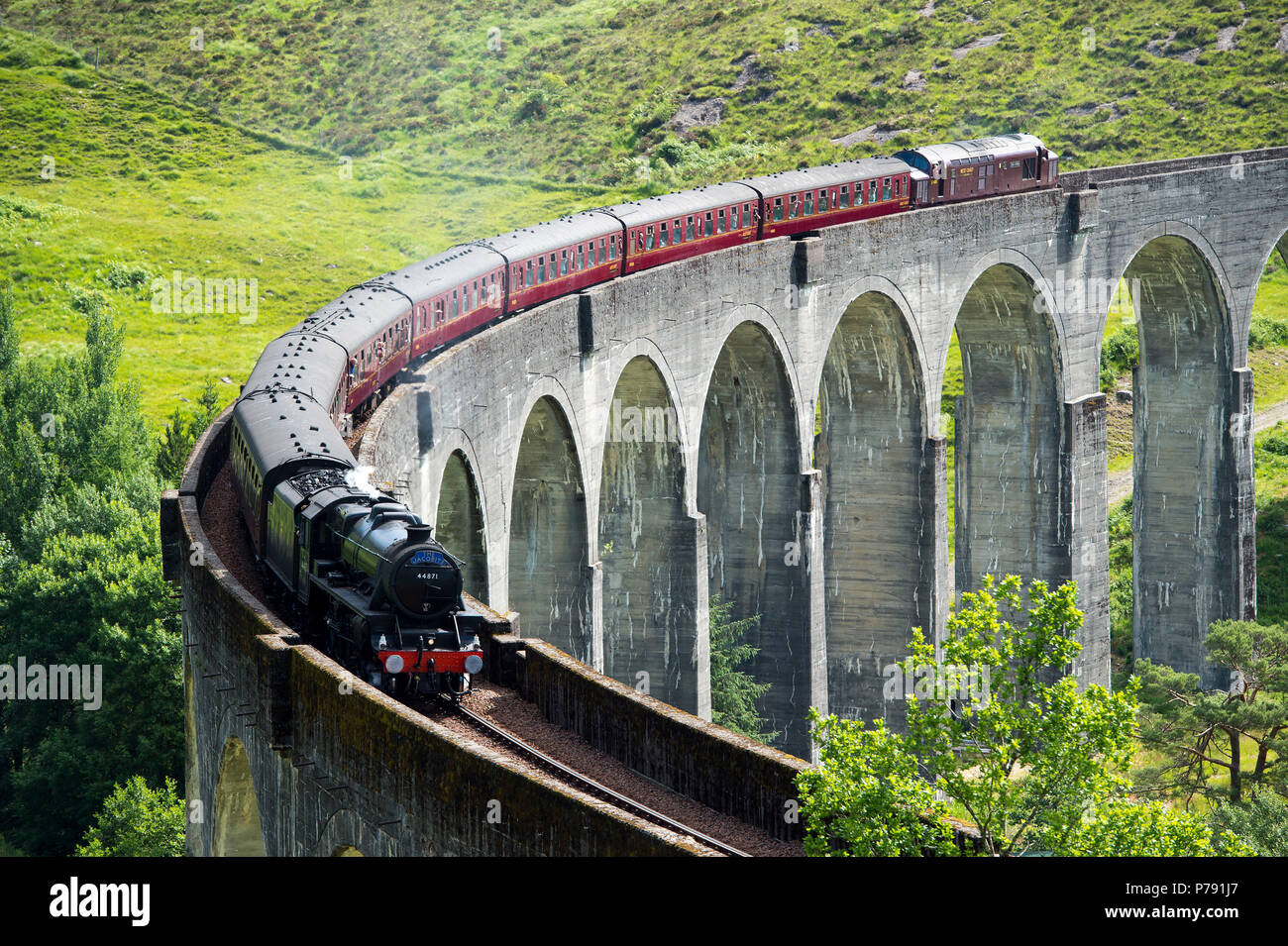 The Jacobite Express also known as the Hogwarts Express crosses the Glenfinnan Viaduct on route between Fort William and Mallaig. Stock Photo
