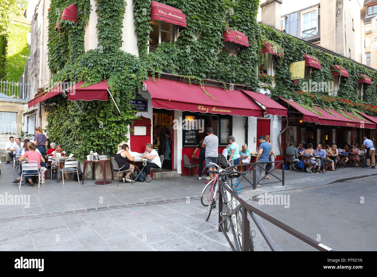 View of typical French cafe Chez Marianne in the quarter Marais, the historic Parisian district set on the Right Bank . Stock Photo