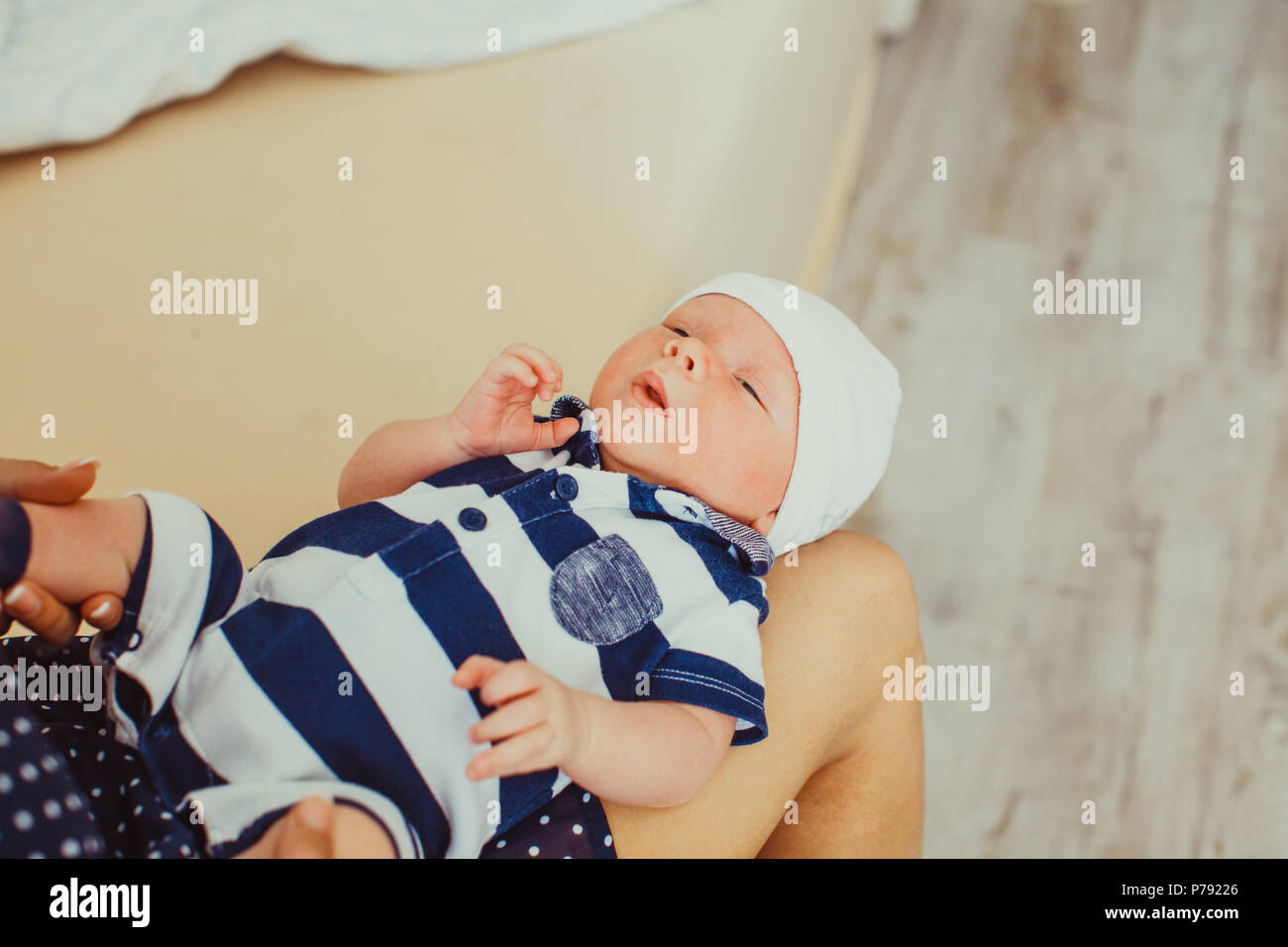 Newborn baby on mother's knees Stock Photo Alamy
