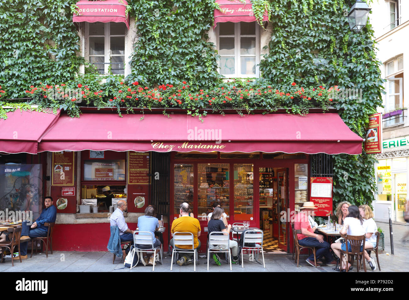View of typical French cafe Chez Marianne in the quarter Marais, the historic Parisian district set on the Right Bank . Stock Photo