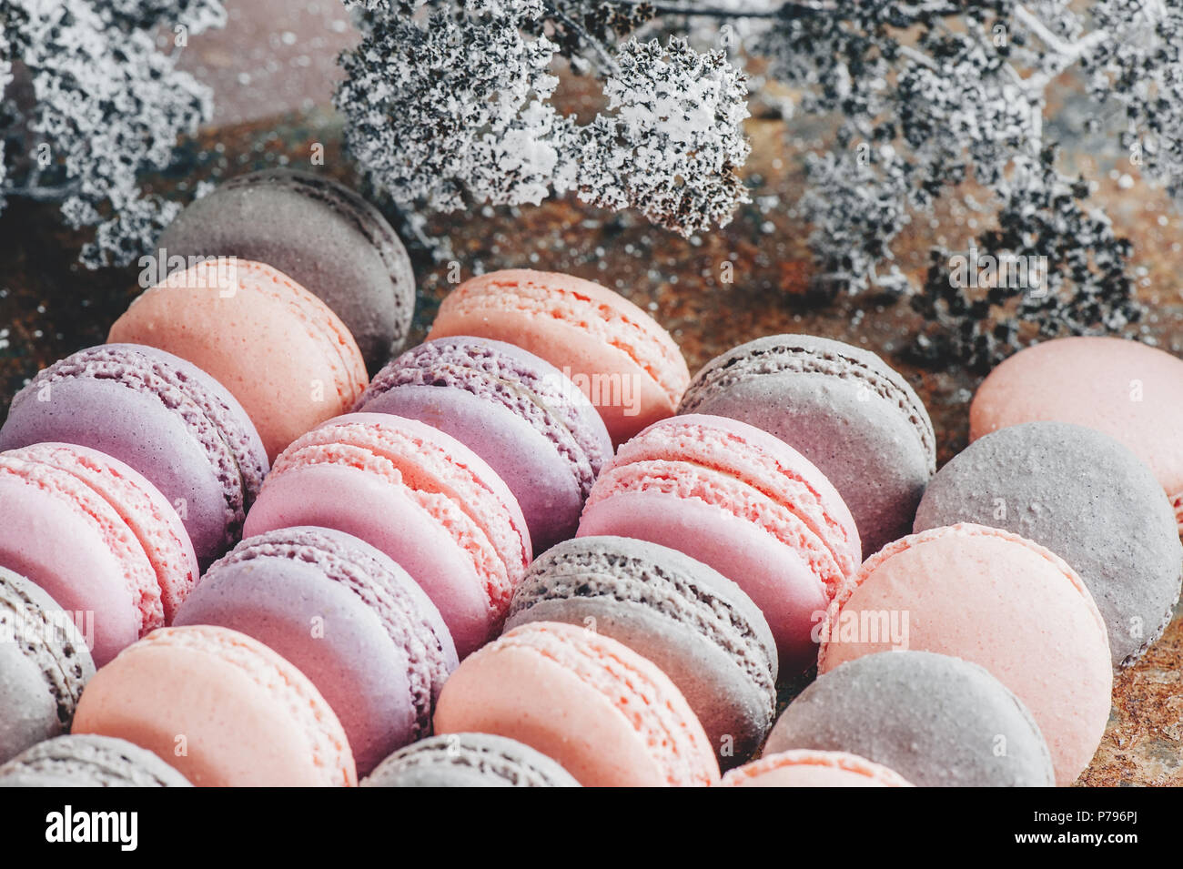 Freshly baked multi-colored macaroons close-up, selective focus. Stock Photo