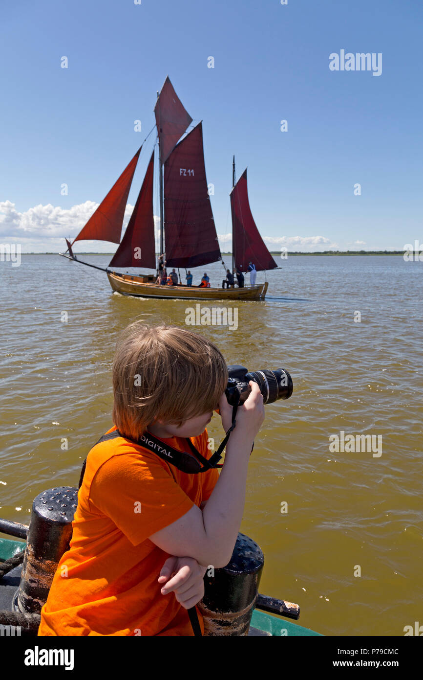 young boy taking photos of Zeesboot Regatta, Wustrow, Fischland, Mecklenburg-West Pomerania, Germany Stock Photo