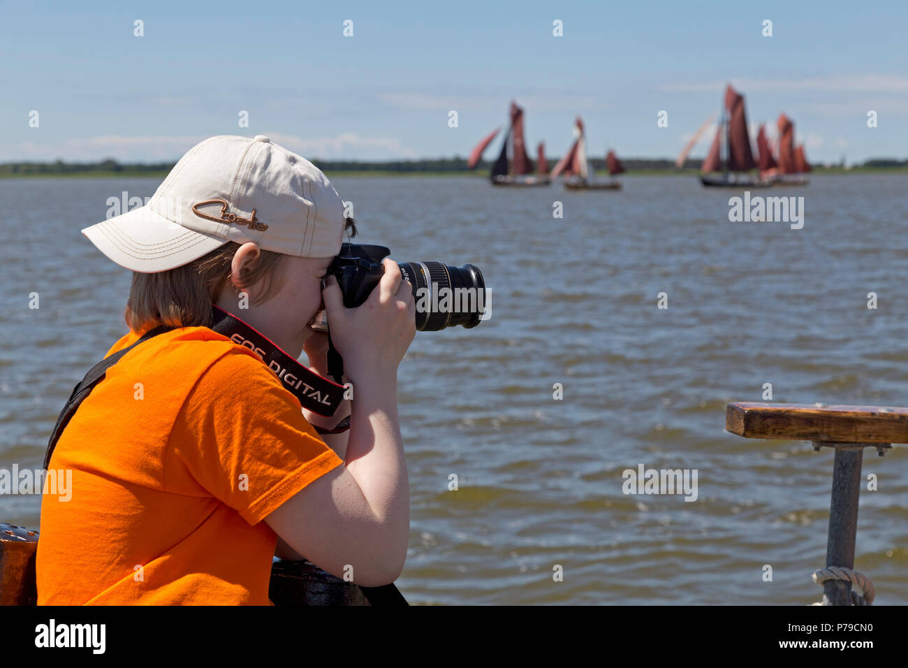 young boy taking photos of Zeesboot Regatta, Wustrow, Fischland, Mecklenburg-West Pomerania, Germany Stock Photo