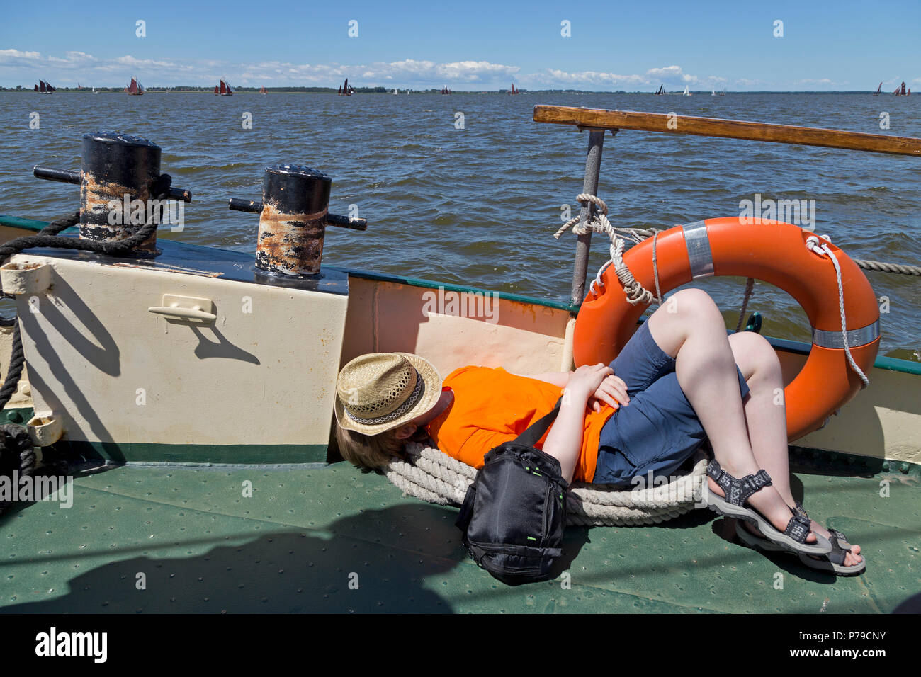 young boy asleep during Zeesboot Regatta, Wustrow, Fischland, Mecklenburg-West Pomerania, Germany Stock Photo