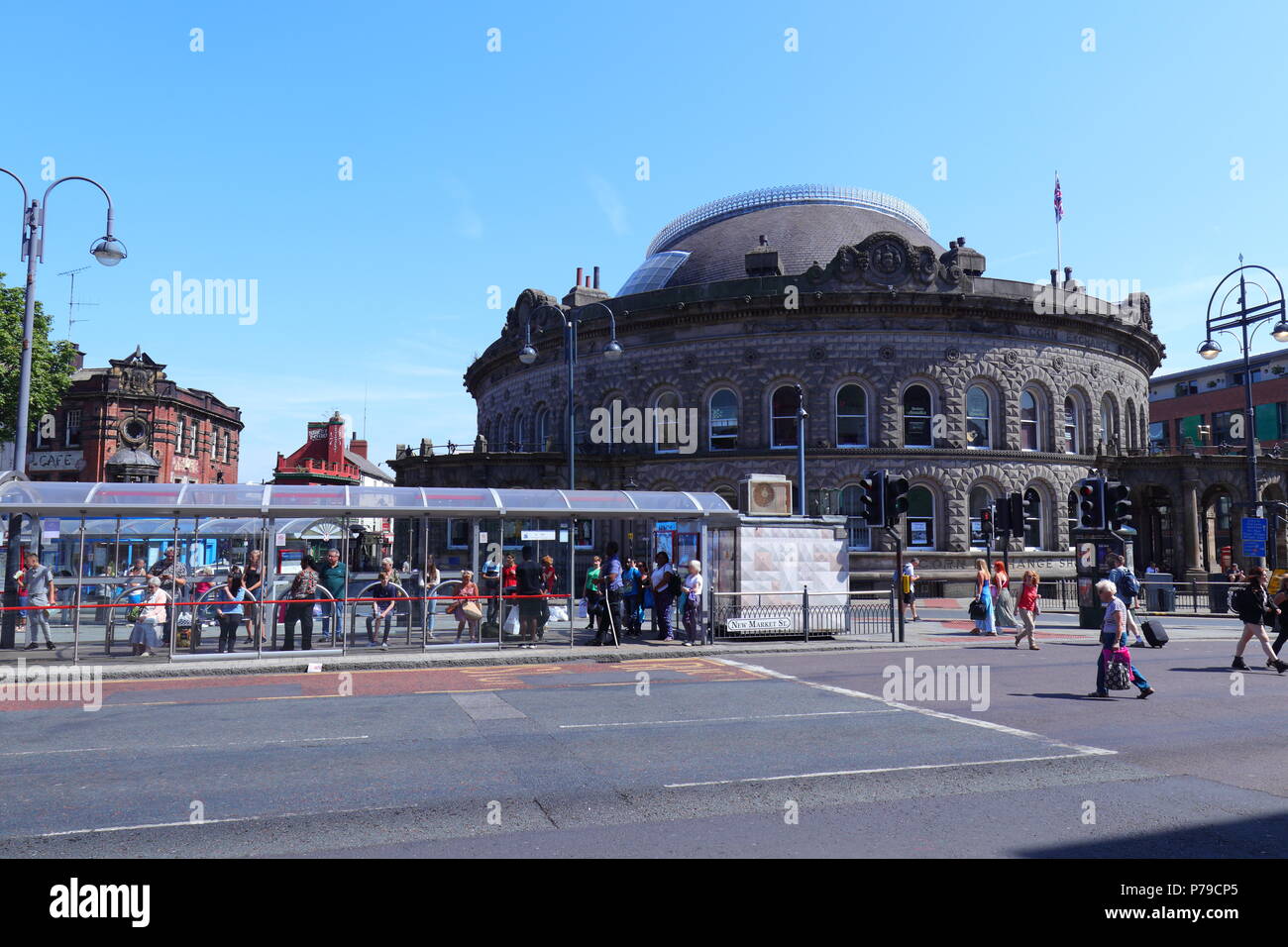 The Corn Exchange with a busy bus stand just outside on New Market Street in Leeds City Centre Stock Photo