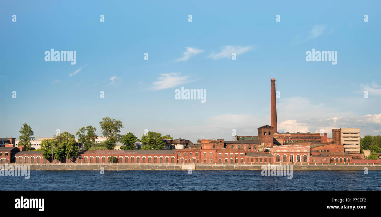 Old stationery factory at Neva river quay panoramic view. Red brick