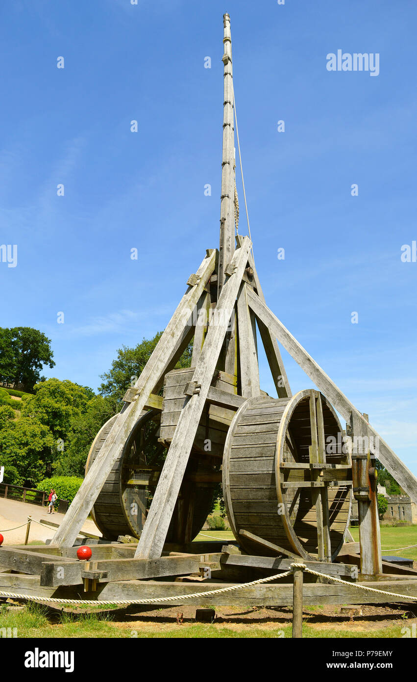 The trebuchet the French name for catapult in Warwick Castle uses a swinging arm to t Stock Photo