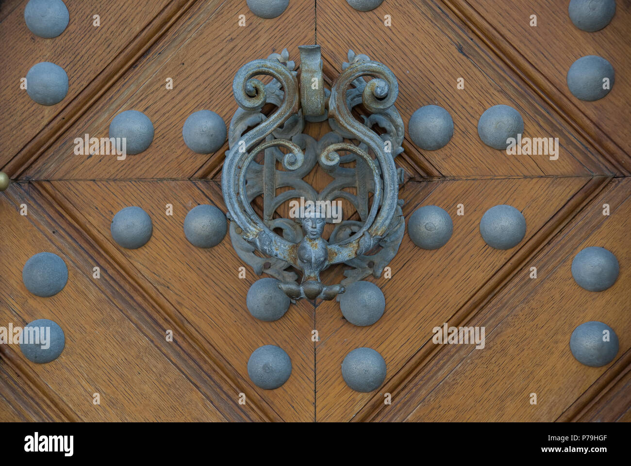 Iron decorative handle of the wooden entrance door to the Schwarzenberg palace (the black palace), the National Gallery in Prague Stock Photo