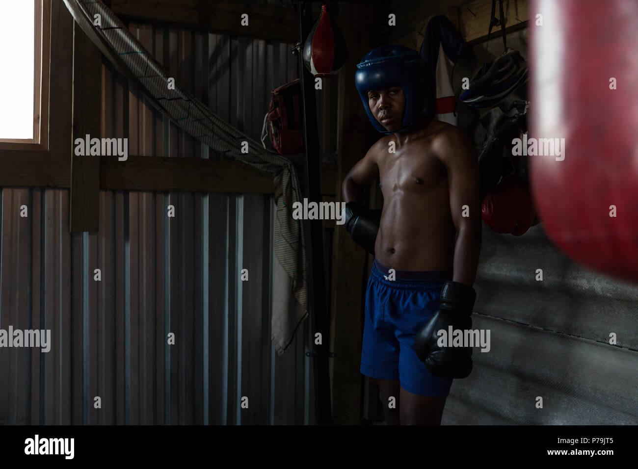 Male boxer practicing boxing in fitness studio Stock Photo