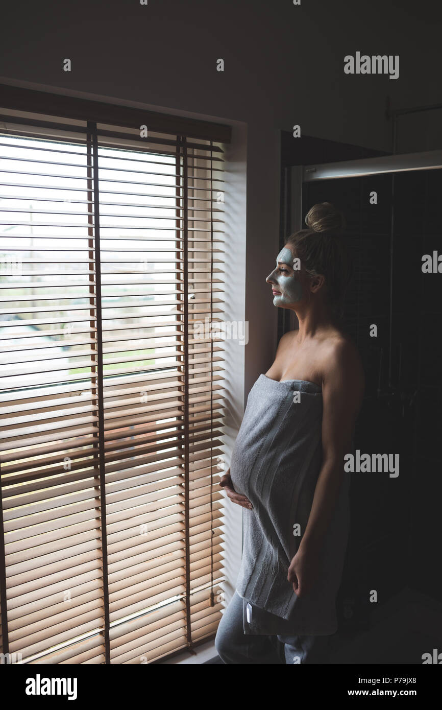 Pregnant woman with facial cream in bathroom Stock Photo Alamy