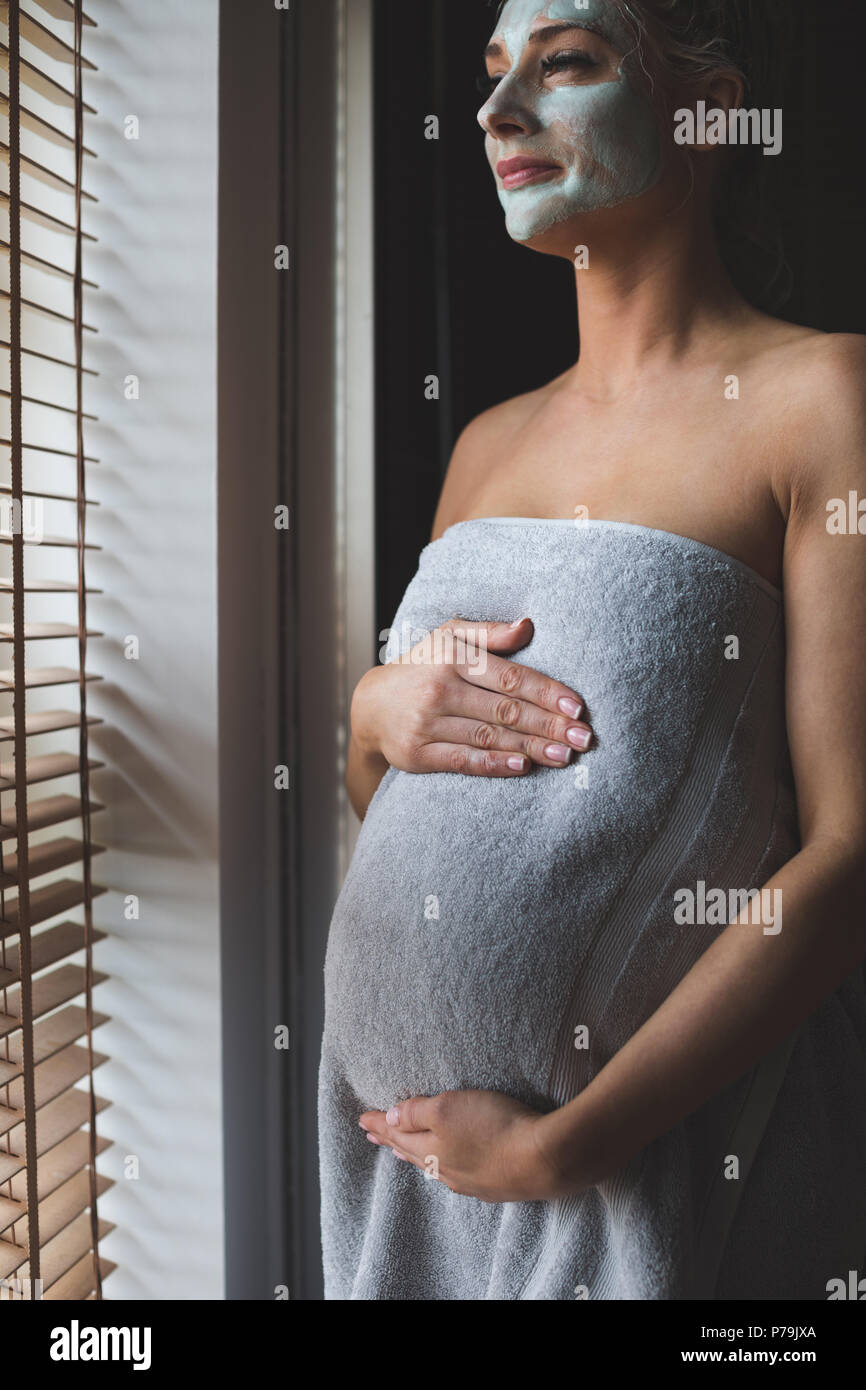 Pregnant woman with facial cream in bathroom Stock Photo Alamy