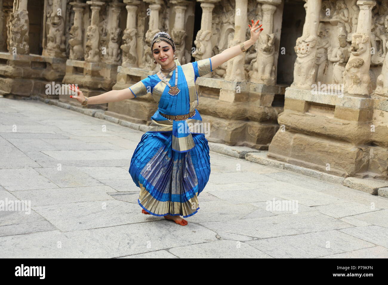 bharatha natyam,one of the eight classical dance forms of india,is from the state of tamil nadu.here the dancer performs before temples with sculpture Stock Photo