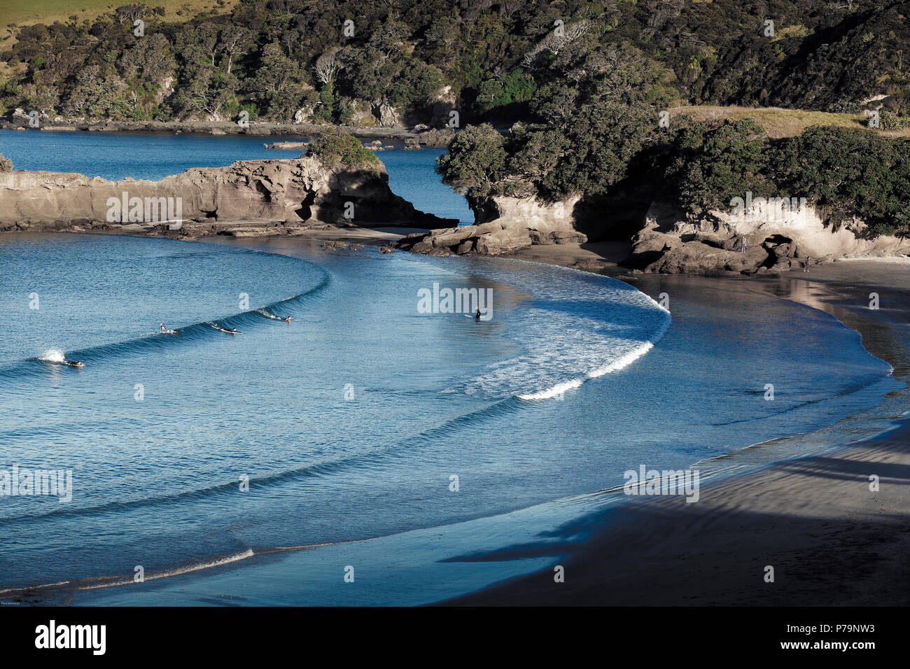 Scenic view of people surfing at Tawharanui beach, New Zealand Stock Photo