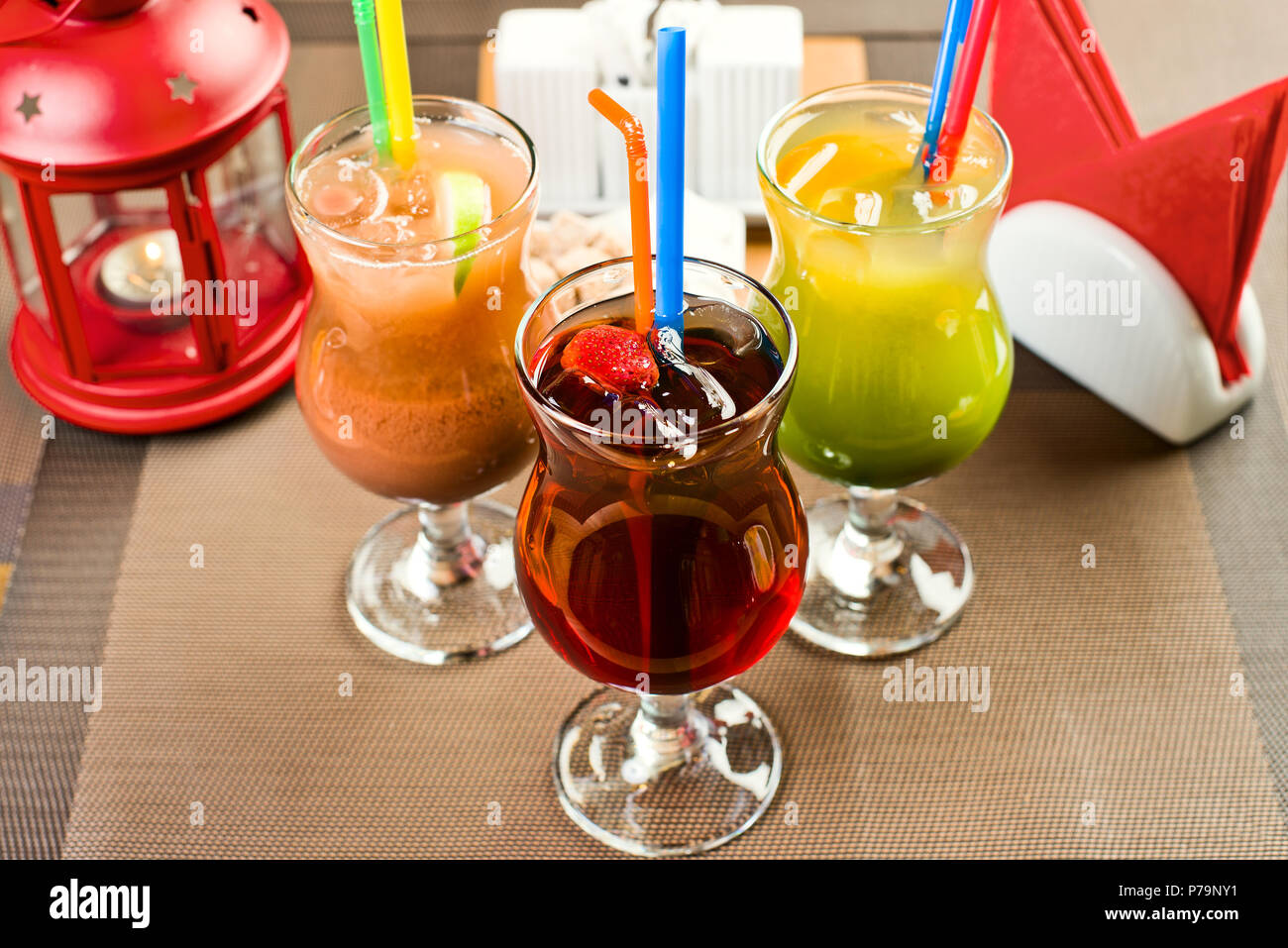 three glass with strawberry, lemon and chocolate cocktail  - daiquiri with ice, on table in restaurant Stock Photo