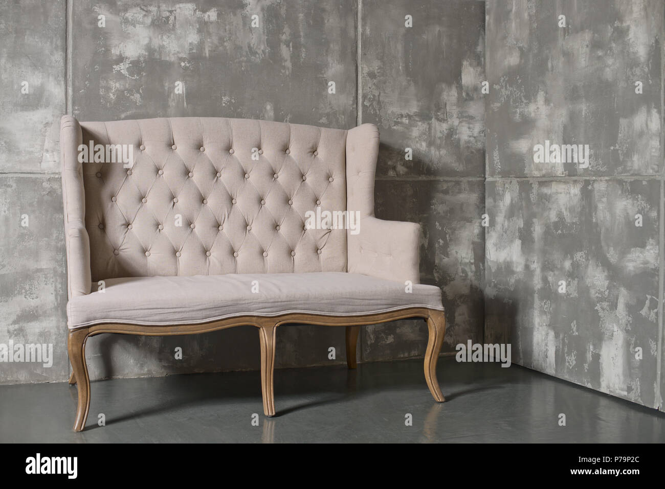 one soft chair on dark grey background,  horizontal photo Stock Photo