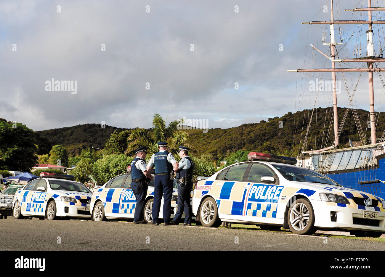 Police officers and patrol cars on standby at Waitangi Day celebrations in Waitangi, Bay of Islands, New Zealand Stock Photo