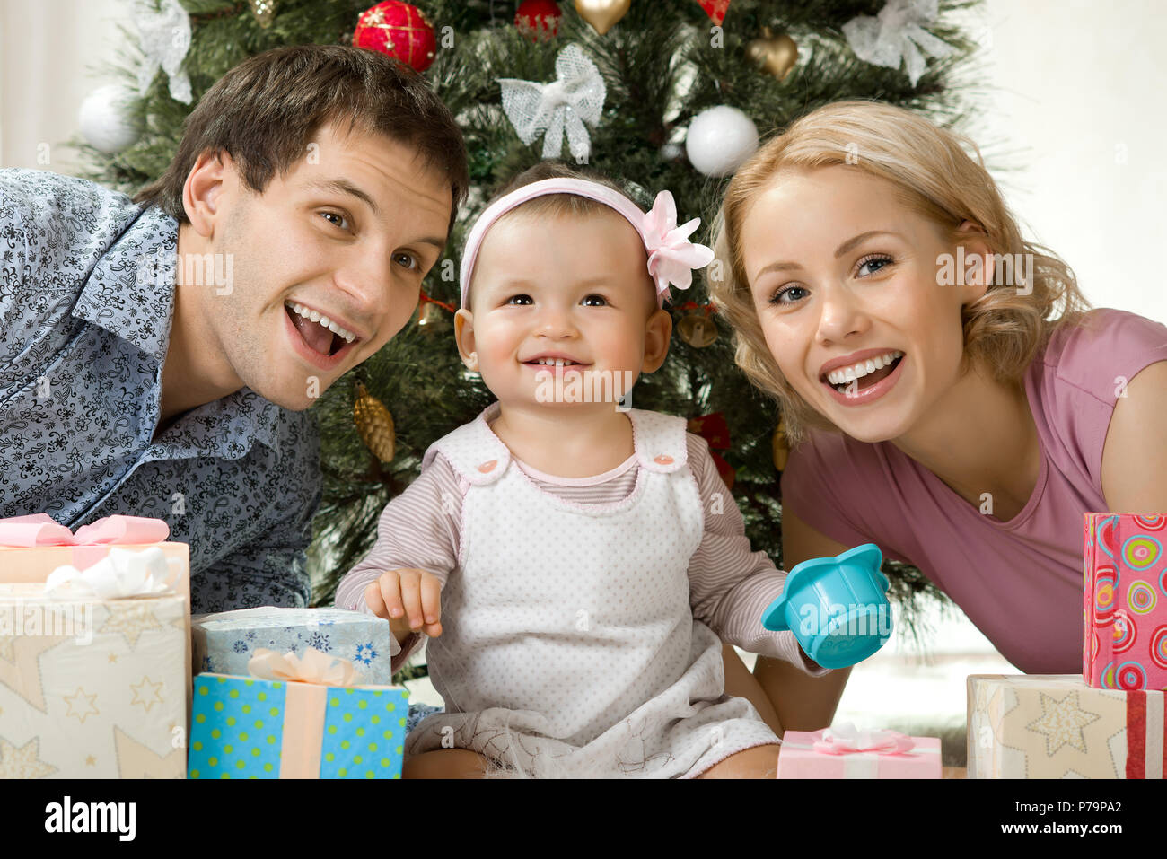 portrait very happy family in home with Christmas-tree and gift, smile Stock Photo