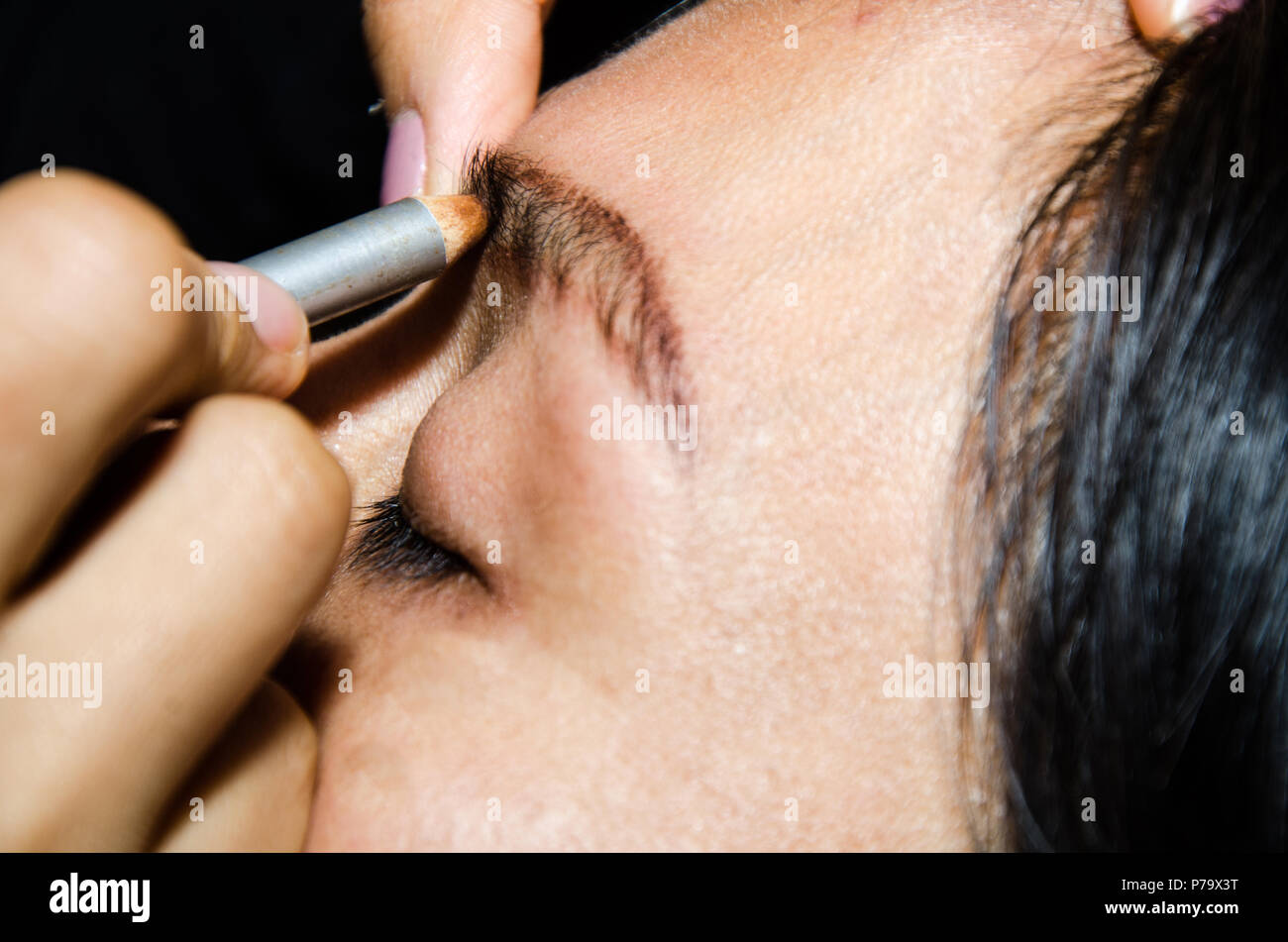 Permanent makeup tattooing of eyebrows. Cosmetologist applying permanent make up on eyebrows - eyebrow tattoo Stock Photo