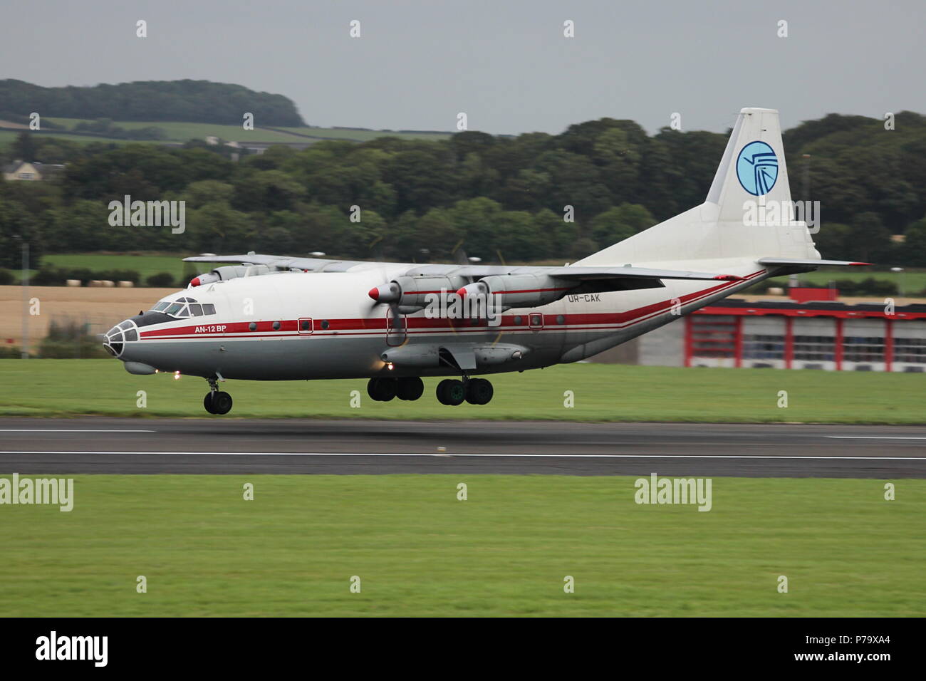 UR-CAK, an Antonov An-12BP cargo aircraft operated by Ukraine Air Alliance, landing nosewheel first at Prestwick Airport in Ayrshire. Stock Photo