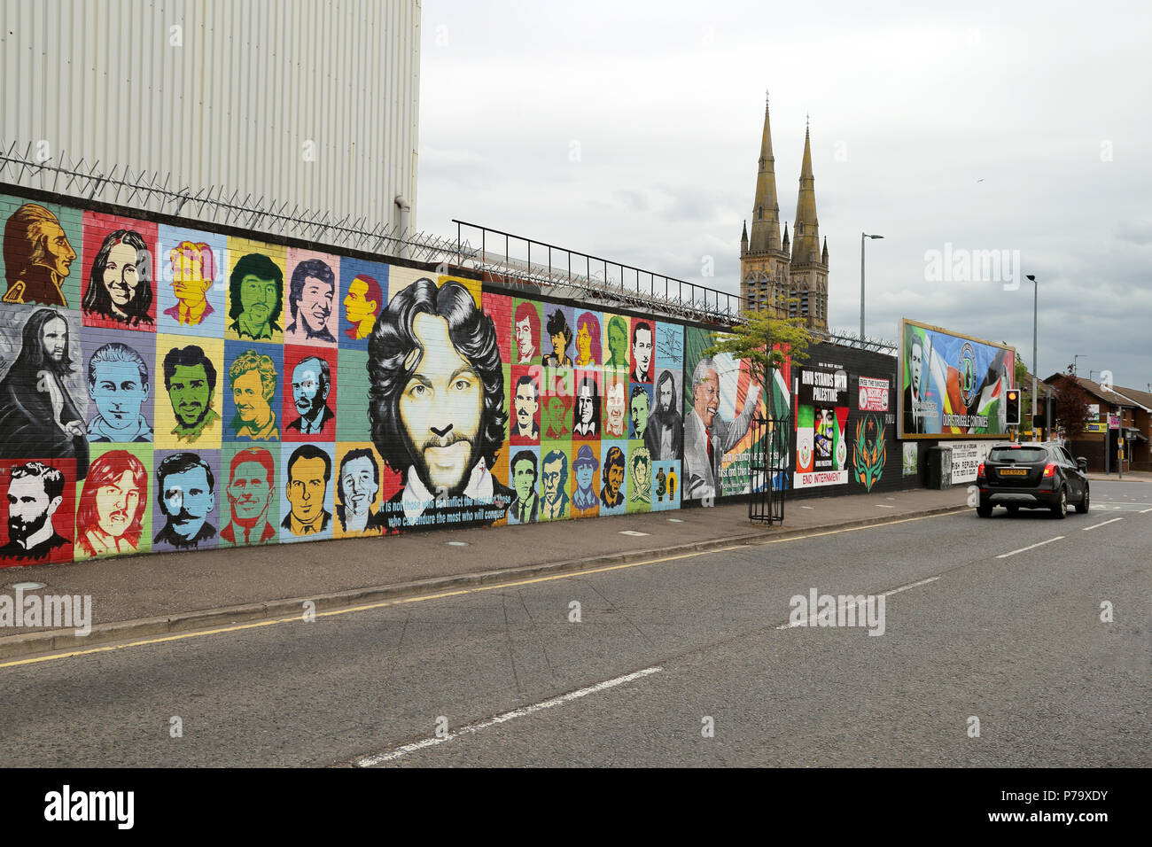 Political grafitti covers the Peace Wall in Belfast, Northern Ireland. The walls were erected to seperate the Republican and Loyalist populations duri Stock Photo