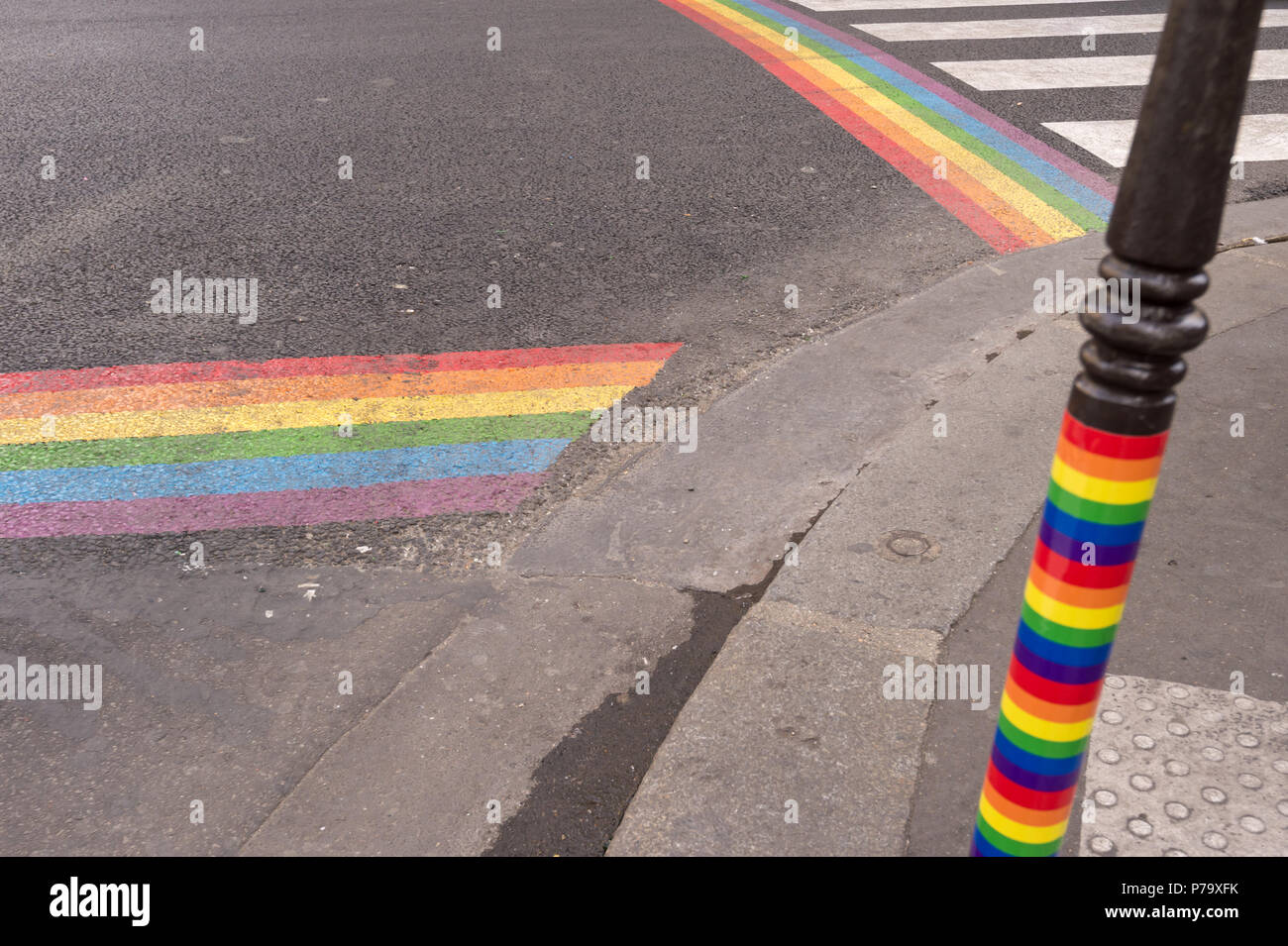 Gay pride flag crosswalks in Paris gay village (Le Marais) Stock Photo
