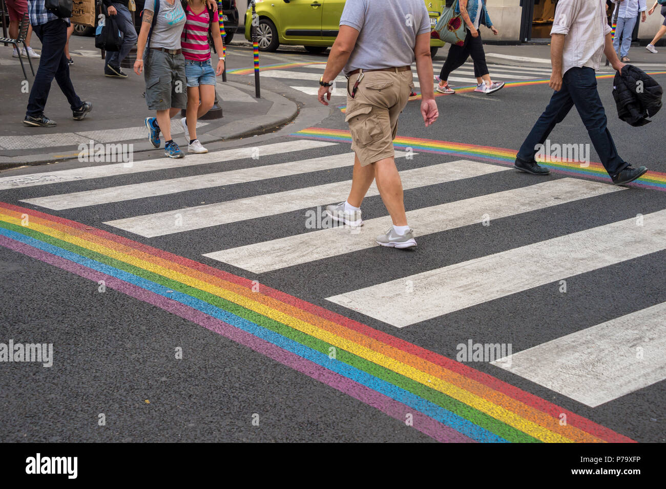Paris, France - 24 June 2018: Gay pride flag crosswalk in Paris gay village with people crossing Stock Photo