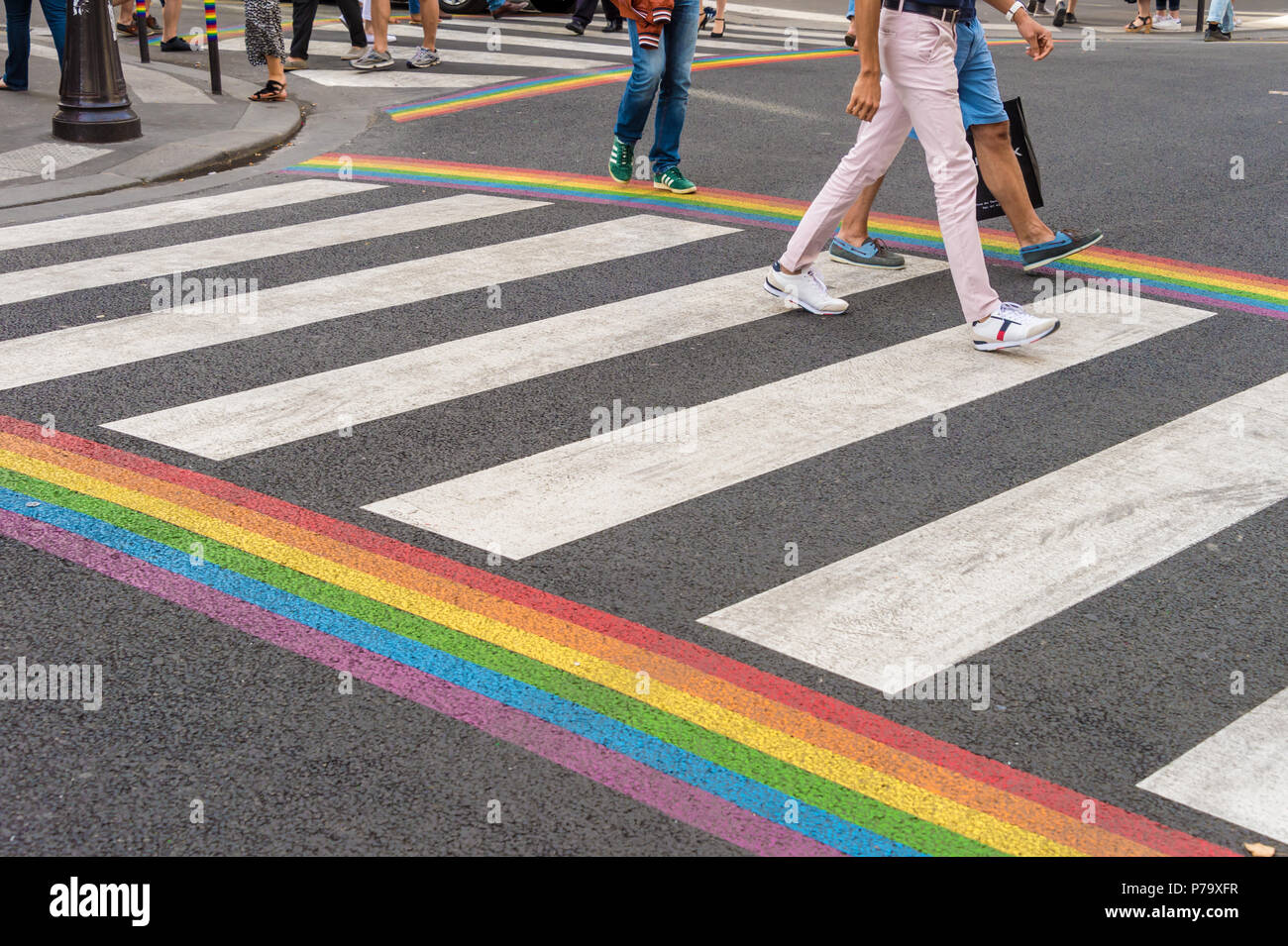 Paris, France - 24 June 2018: Gay pride flag crosswalk in Paris gay village with people crossing Stock Photo