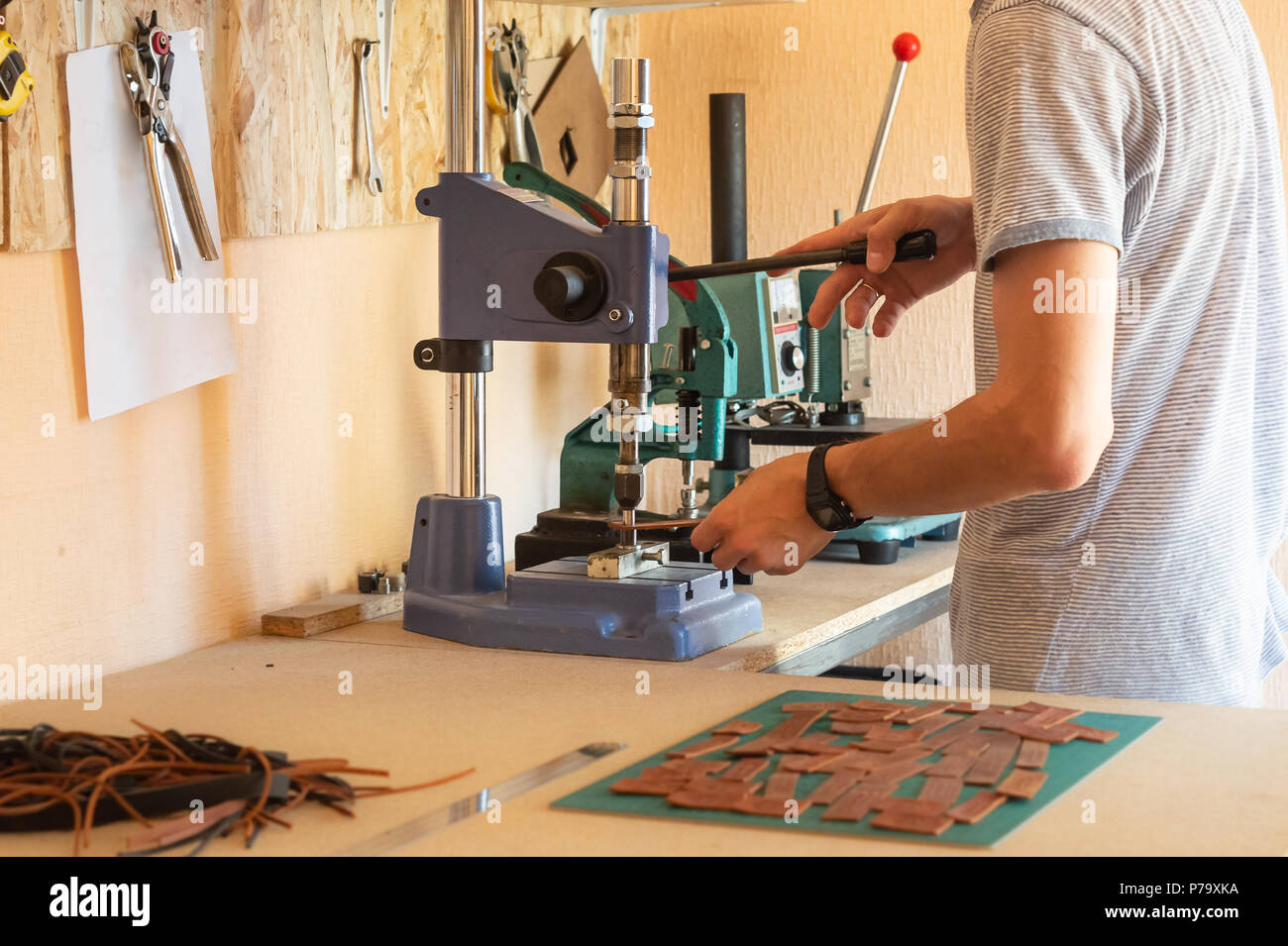 Working with pressing machine in small diy leather Male hands