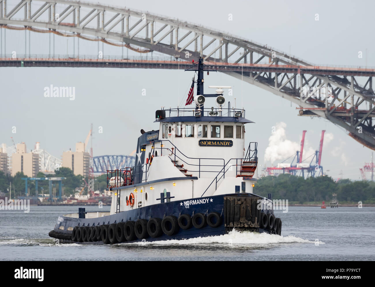 Metropolitan Marine Transportation tug boat Normandy; Kill Van Kull with the Bayonne Bridge and Staten Island view of Newark Bay behind her. Stock Photo