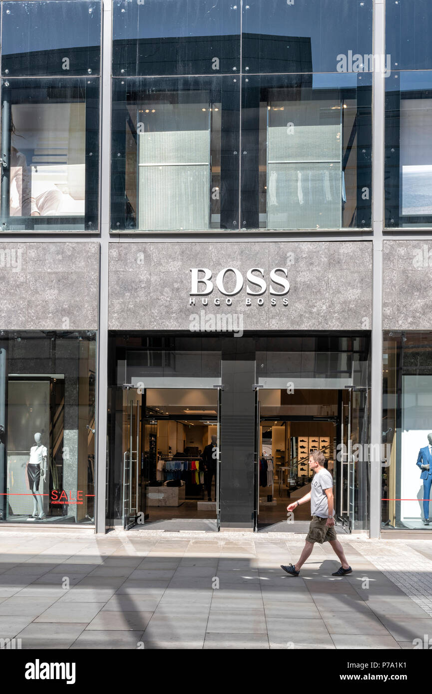 Man walking past a Hugo Boss shop in the centre of Manchester, UK Stock  Photo - Alamy