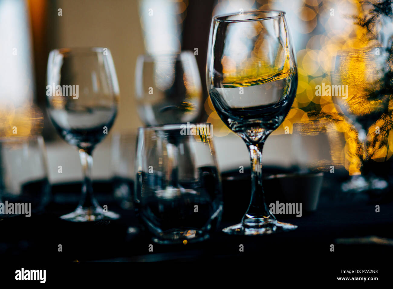 Luxury table settings for fine dining with and glassware, beautiful blurred  background. For events, weddings. WEDDINGS, Wedding detals and planing. Stock Photo